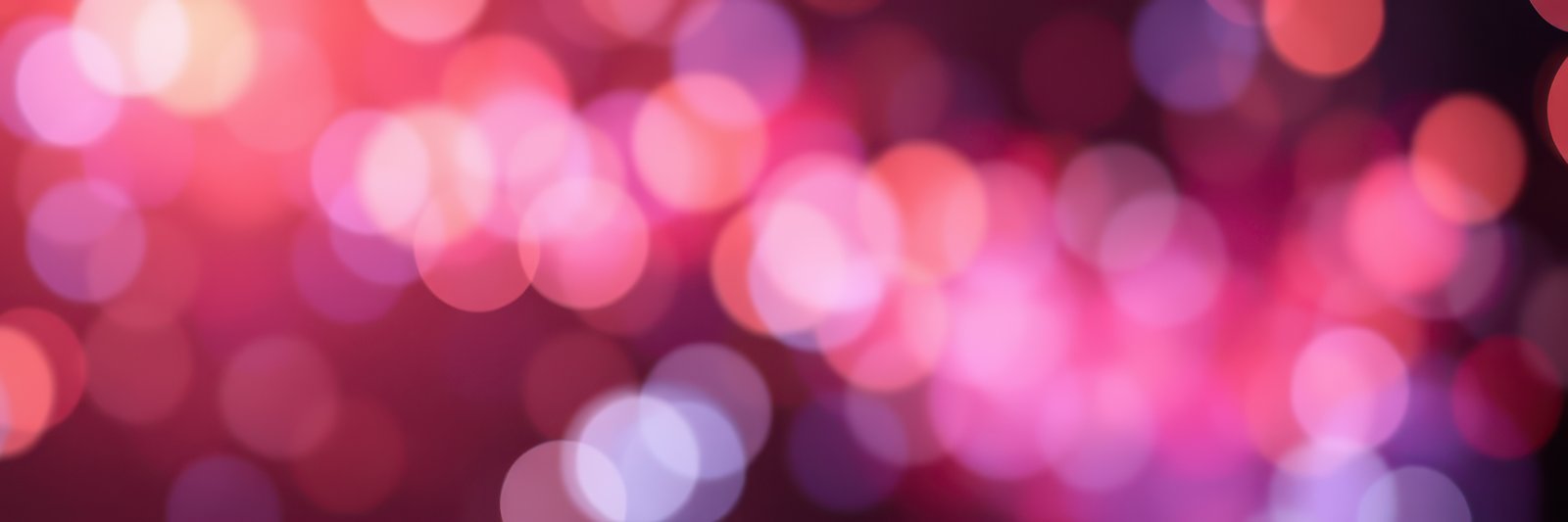 Colorful bokeh lights create a vibrant atmosphere at a festive gathering in the evening